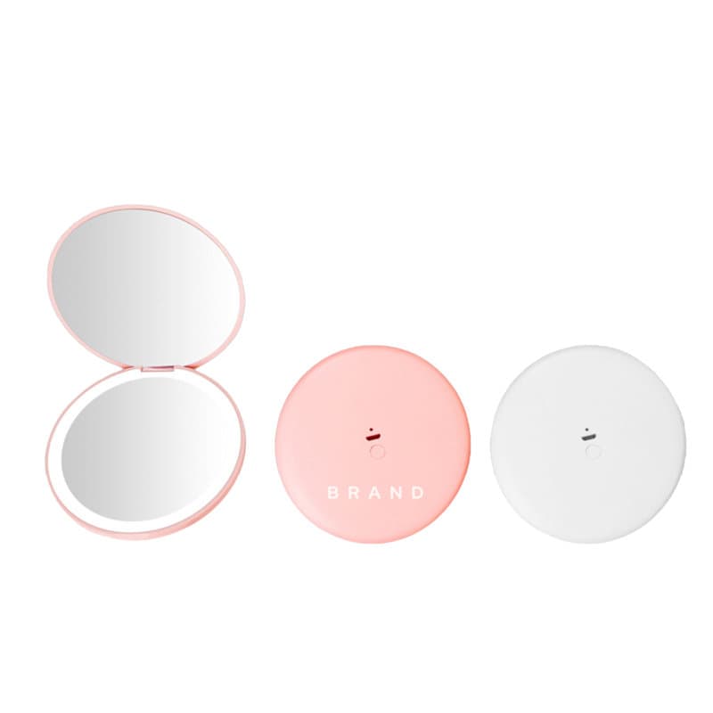 A folding vanity compact mirror with light in pink and white, featuring a logo on the front of the pink case. Folding Vanity Compact Mirror With Light - Image 1
