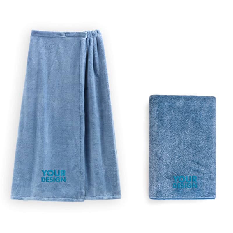 A light blue women's adjustable bath wrap with a matching towel, featuring a logo design. Women's Adjustable Bath Wrap - Image 1