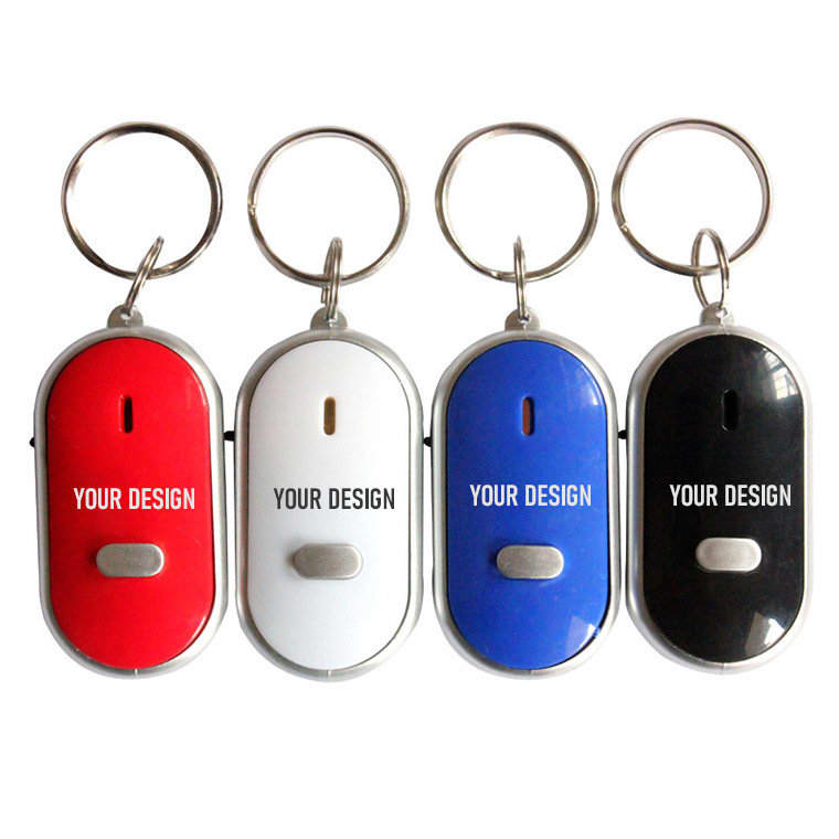 A set of four portable key finders in red, white, blue, and black, each with a keyring attachment. Portable Key Finder With Whistle - Image 1