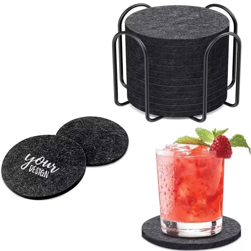 A set of round black felt coasters in a metal holder, with a drink placed on one coaster. Personalized Felt Coaster Set - Image 1