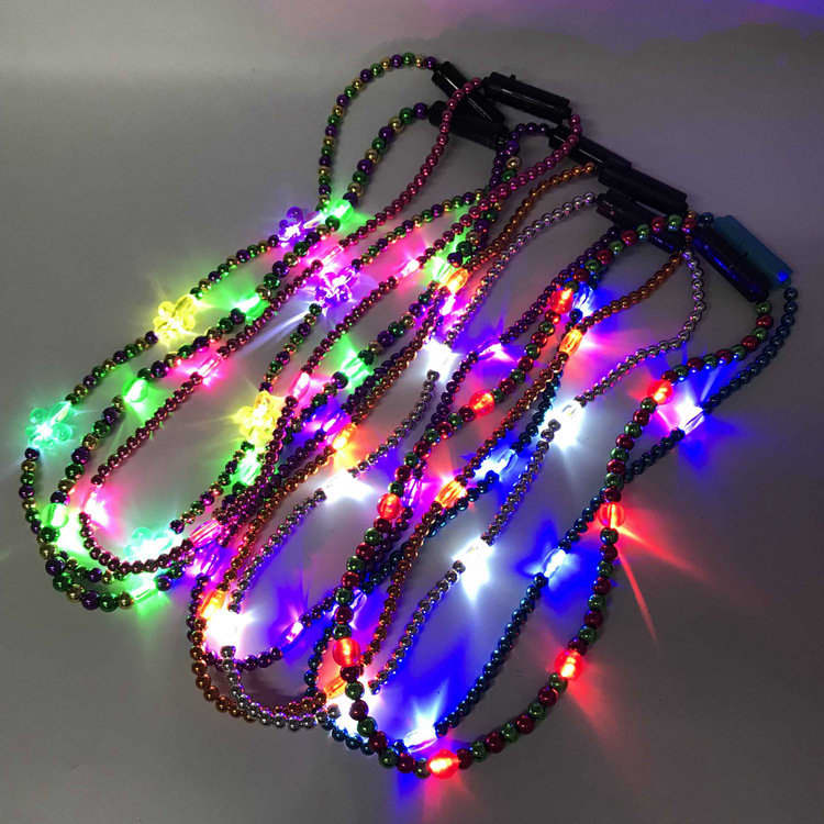 A collection of multicoloured LED bead necklaces illuminated with vibrant lights on a grey background. Light Up LED Bead Necklaces - Image 1